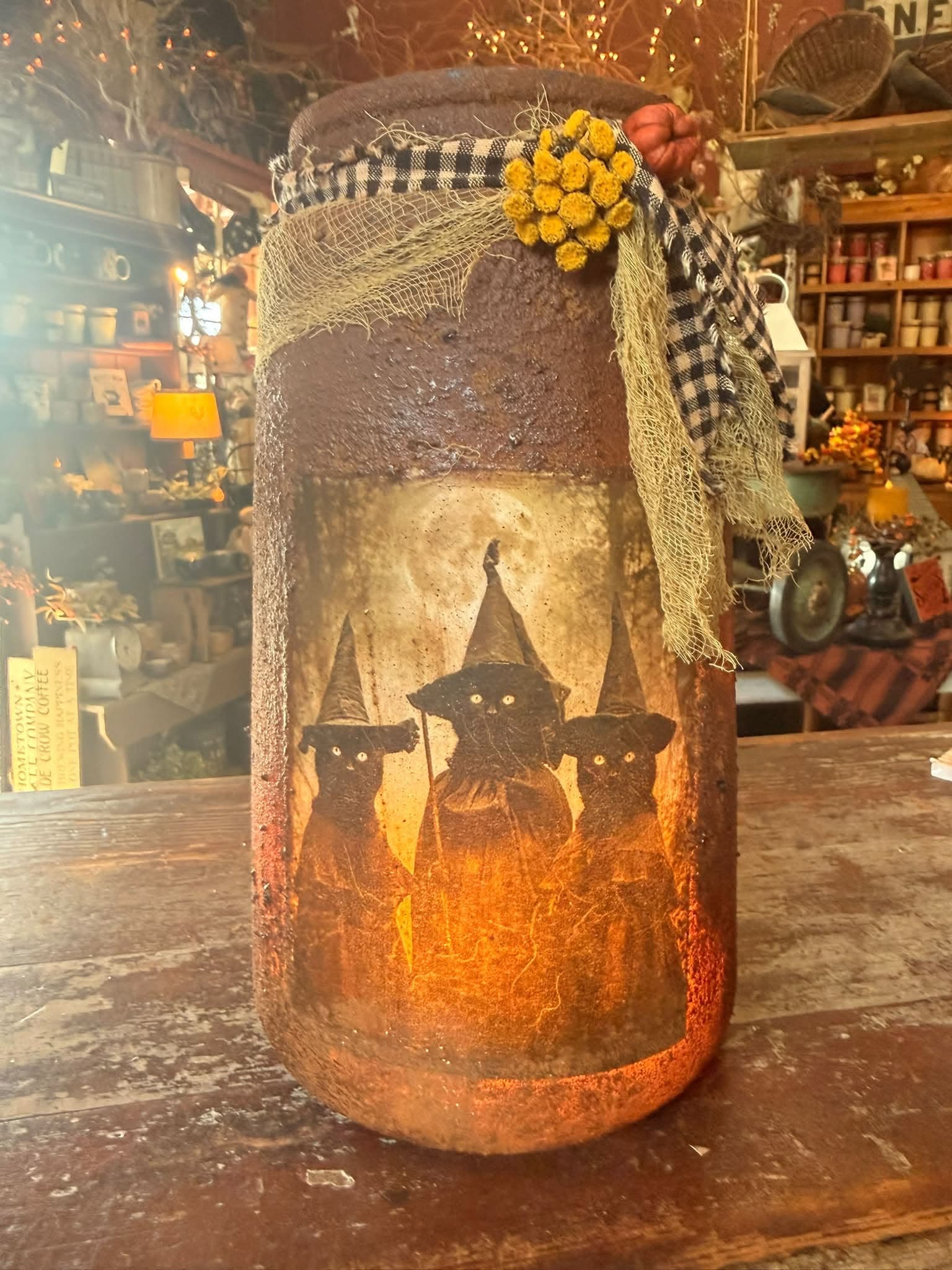 An aged primitive candle crock in the warmly lit shop interior